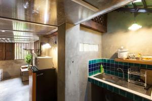 a kitchen with a sink and a counter top at Chiang Mai Summer Resort in Chiang Mai