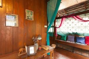 a room with two bunk beds and a window at Chiang Mai Summer Resort in Chiang Mai