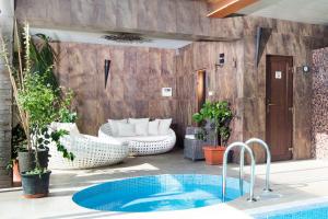 a patio with a plunge pool and a couch at Alzbeta resort - Aqua & Wellness in Liptovský Mikuláš