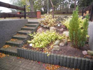 a garden with stairs and plants and a fence at Ferienwohnung Krentz in Neu Sallenthin