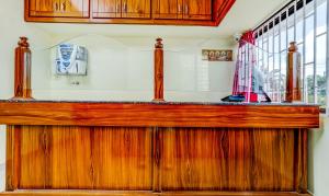 a wooden counter top in a room with a window at Hotel Umaiyyal International in Kanyakumari