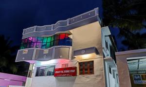 a building with a rainbow colored facade at night at Hotel Umaiyyal International in Kanyakumari