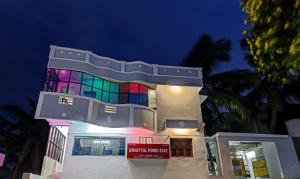 a large building with a colorful facade at night at Itsy By Treebo - Umaiyyal Home Stay in Kanyakumari