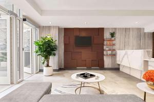 a living room with a couch and a table at Wingate by Wyndham New York Midtown South/5th Ave in New York