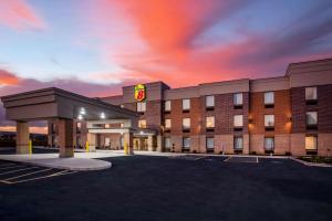 a hotel with a parking lot in front of it at Super 8 by Wyndham St. Louis North in Saint Louis