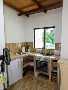 a kitchen with a counter and a sink and a window at Posada Bavaria in Trinidad