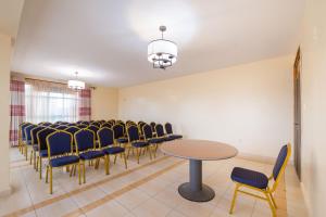 a conference room with a table and chairs at Maple Inn Hotel in Nairobi