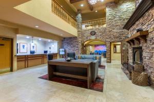 an office lobby with a stone wall and a fireplace at La Quinta by Wyndham Vancouver in Vancouver