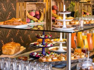 a buffet with many different types of food on display at Mercure Toulouse Centre Saint-Georges in Toulouse