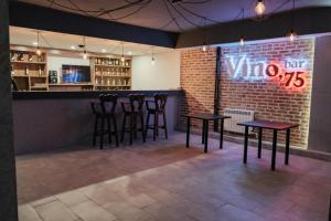 a bar with stools and a sign that says wine at BOUTIQUE HOTEL 1967 AQSAI in Aksay