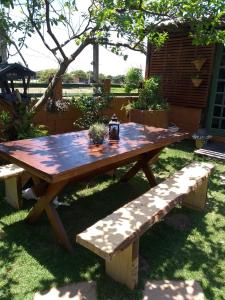 a wooden picnic table and benches in a yard at Solar Lisboa 100 m da Praia com vista para mar in Balneário Camboriú