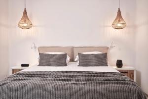 a bed with two lamps on top of it at Mykonos Bliss - Cozy Suites, Adults Only Hotel in Kalo Livadi