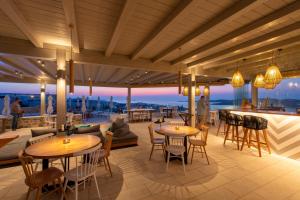 a rendering of a rooftop patio with tables and chairs at Sunset View Hotel in Parikia