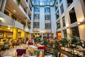 a restaurant with tables and chairs in a building at Xima Exclusive Cusco in Cusco