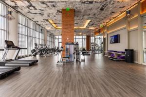 a gym with treadmills and cardio equipment in a building at Ocean Breeze Retreat - Pool Gym Access Views in Hallandale Beach