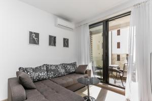 a living room with a couch and a table at Apartments BEATRICE Rafailovici in Rafailovici