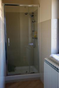 a shower with a glass door in a bathroom at Le Villette in Frascineto +14 photos