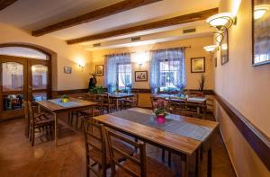 a dining room with wooden tables and chairs at Penzión Harmony in Poprad