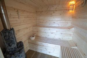 a wooden sauna with a bench in the corner at Panoramic Residence in Borşa