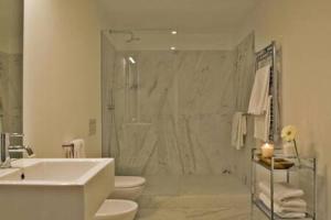 e bagno con doccia, servizi igienici e lavandino. di Lisbon Combro 77 Charming Studios by Get Your Stay a Lisbona