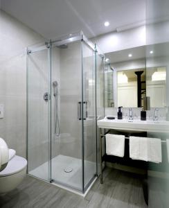 a bathroom with a shower and a toilet and a sink at Pensión Plaza Nueva in Bilbao +35 photos