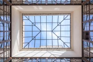 a large window in a building with the sky in the background at Palacio Solecio, a Small Luxury Hotel of the World in Málaga