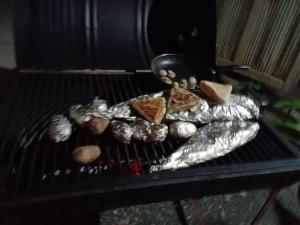 a grill with meat and food on it at My House Ahangama in Ahangama