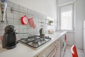 a kitchen with a stove and a stove top at IMHOME - Muratori in Milan