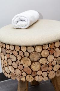 a stool with a white towel on top of a table with wine corks at LUVA Resorts Kappl - Chalet K in Kappl