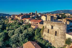 an aerial view of a town with a castle at Golden Tulip Porto-Vecchio in Porto-Vecchio