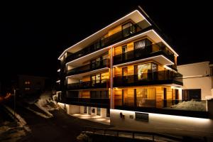 a tall building at night with its lights on at LUVA Resorts Kappl - Chalet K in Kappl