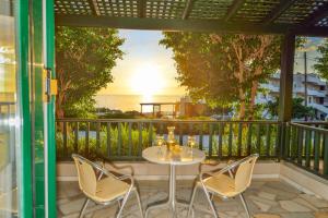 a table and chairs on a balcony with a view of the ocean at Falasarna Bay in Falasarna