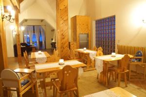 comedor con mesas y sillas de madera en Villa Goździk, en Wisła