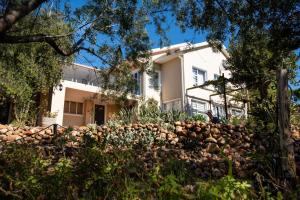 a house with a stone wall in front of it at African Tulip Guesthouse in Tulbagh