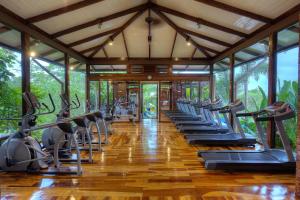 a gym with rows of treadmills and exercise bikes at Nayara Gardens in Fortuna