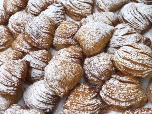 a pile of powdered sugar covered donuts on a table at Grand Hotel Il Ninfeo in Gaeta