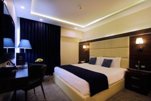 Postel nebo postele na pokoji v ubytování MENA Tyche Hotel Amman