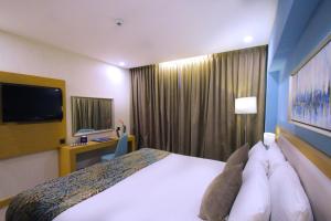 Postel nebo postele na pokoji v ubytování MENA Tyche Hotel Amman