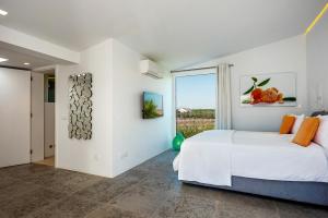 a bedroom with a bed and a large window at Vila Dria in Silves
