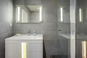 a bathroom with a white sink and a shower at BEAUTY SAINT PAUL in Paris +50 photos