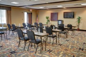 a conference room with tables and chairs and a screen at Holiday Inn Express Hotel & Suites Texarkana East by IHG in Texarkana +37 photos