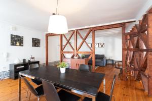 a dining room and living room with a table and chairs at FLH Sé Apartment in Lisbon