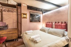 a bedroom with a bed with two towels on it at Casetta Di Carlo Magno in Sutri