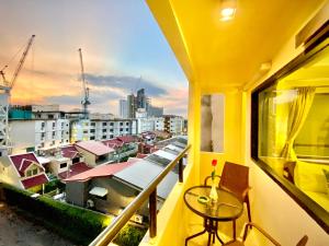 a balcony with a table and a view of a city at New Star in Pattaya