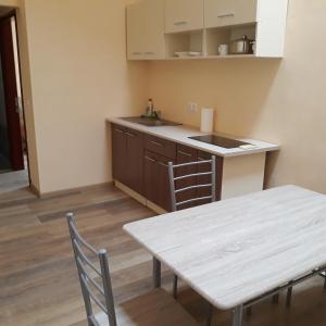 a kitchen with a table and a table and chairs at Veľká Vasylkivska, 132,, in Kyiv