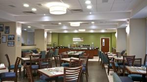 a dining room with wooden tables and chairs at Holiday Inn Express Veracruz Boca del Rio, an IHG Hotel in Veracruz