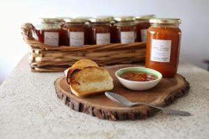 a cutting board with a sandwich and a bowl of sauce at LOS TEROS POSADA DE CAMPO in San Rafael