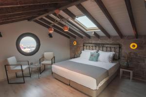 a bedroom with a large bed and a window at Sukha Cunda Otel in Cunda