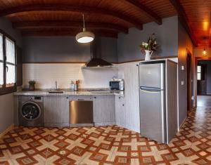 a kitchen with a stainless steel refrigerator and a dishwasher at Apartamentos Miradorderodiles Miramar in Villaviciosa