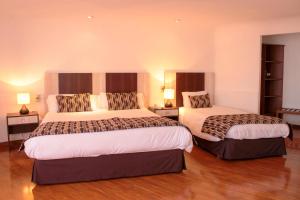 Ein Bett oder Betten in einem Zimmer der Unterkunft Hotel Montecarlo Viña del Mar